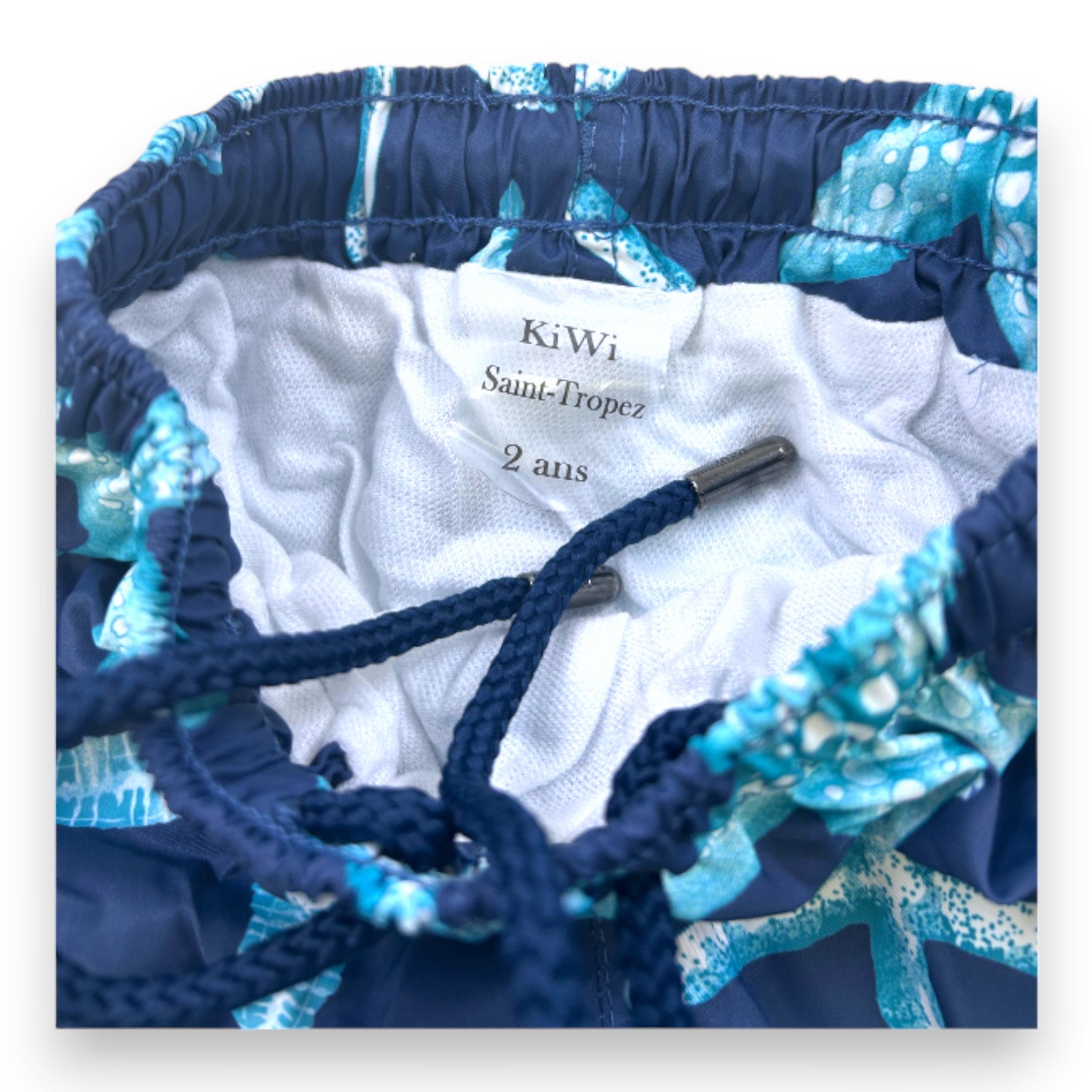 KIWI - Blaue Badeshorts mit Aufdrucken - 2 Jahre